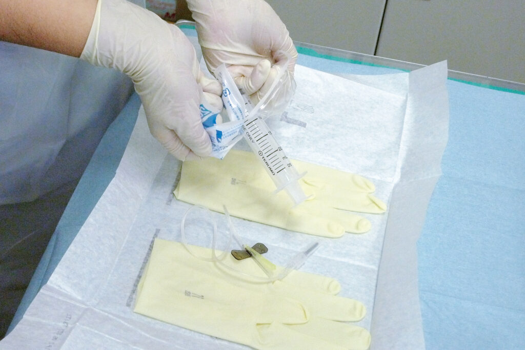 無菌区域に清潔に物品を投下する様子